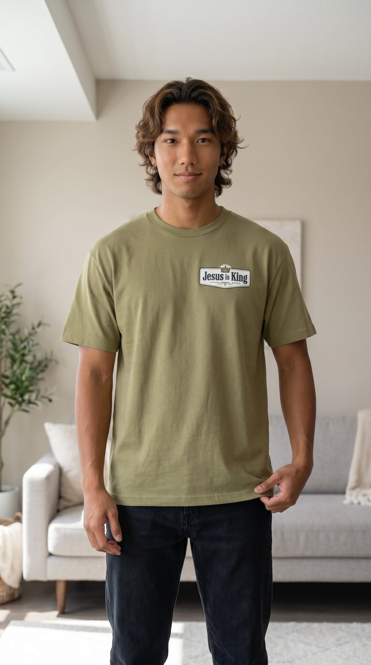 Male model wearing Jesus Is King Christian graphic T-shirt by Daniel Haus Goods, faith-based casual apparel.