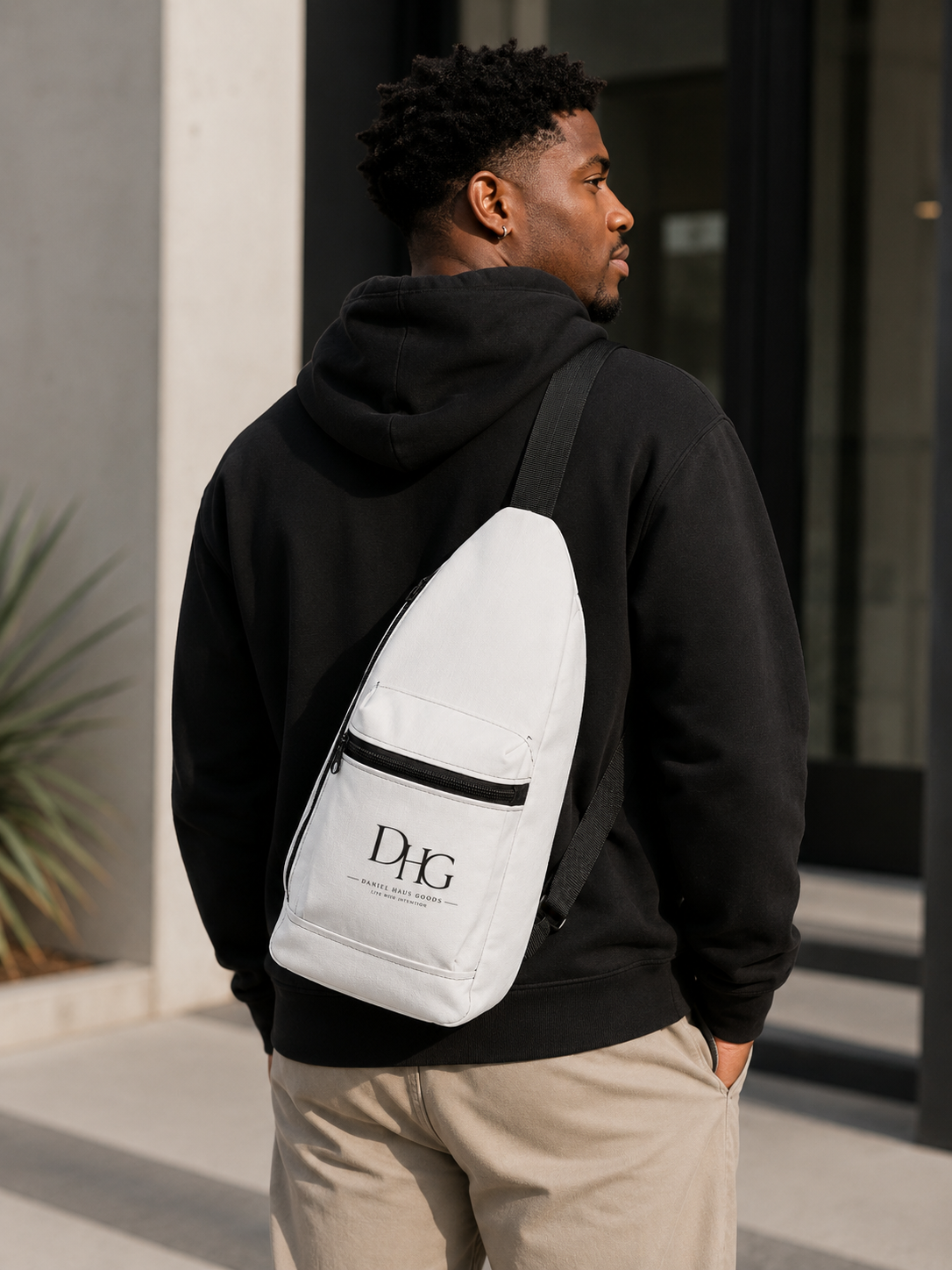 Male model wearing Daniel Haus Goods crossbody sling bag with Christian lifestyle apparel.